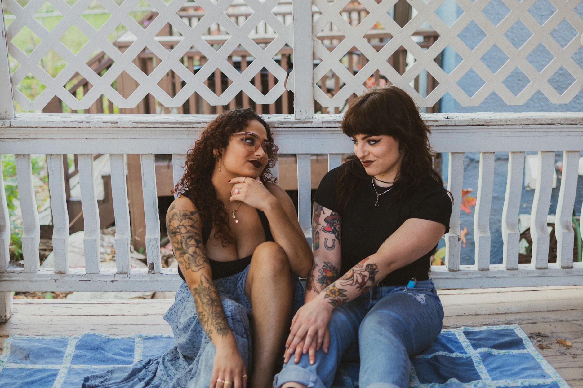 Two friends sitting on a porch in the late afternoon, mid-conversation.