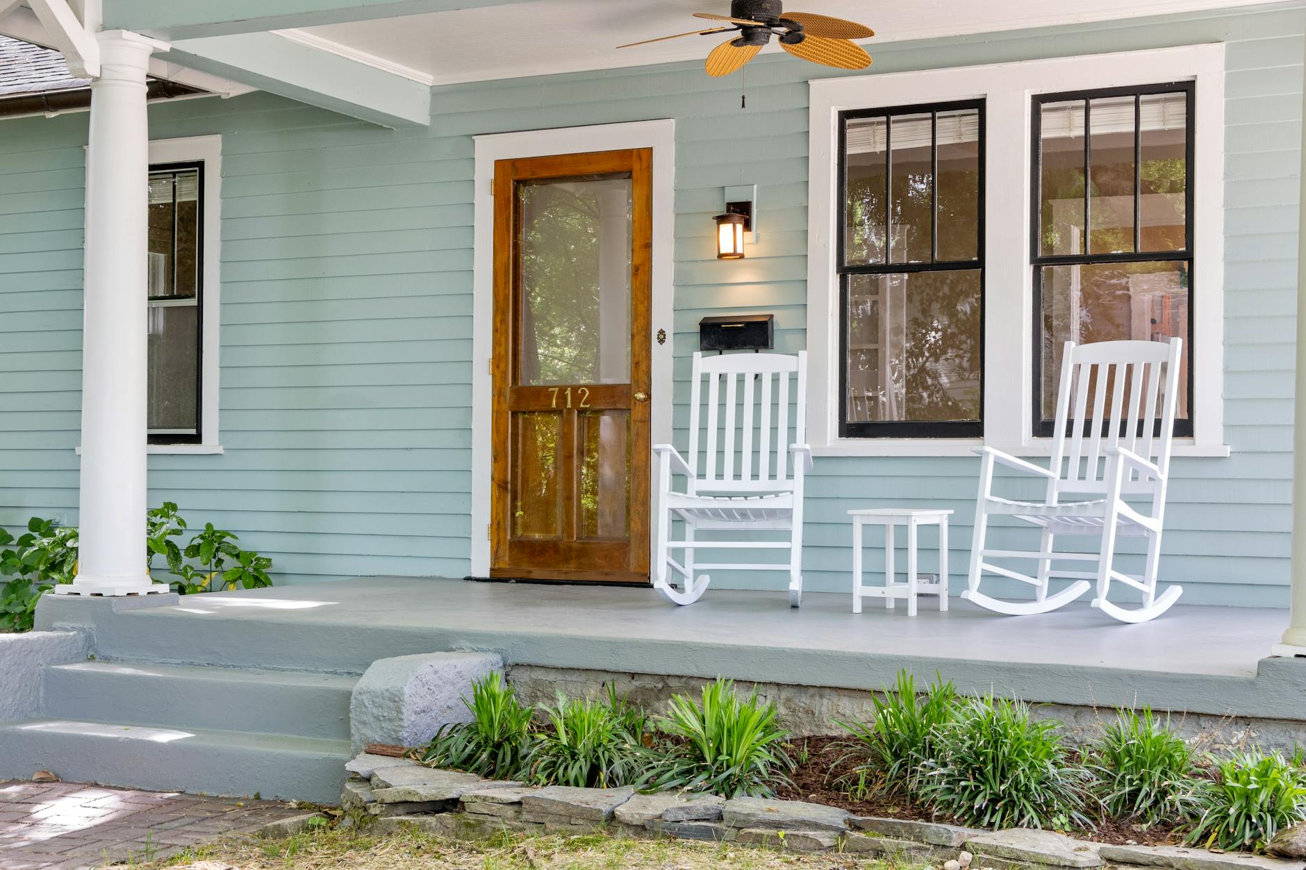 A bungalow in Austin's Hyde Park neighborhood, fronted by a tree-lined sidewalk.