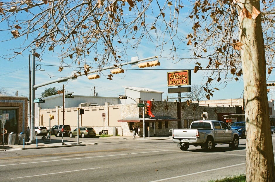 South Congress Avenue in front of Allen's Boots, an Austin landmark, on a clear afternoon.